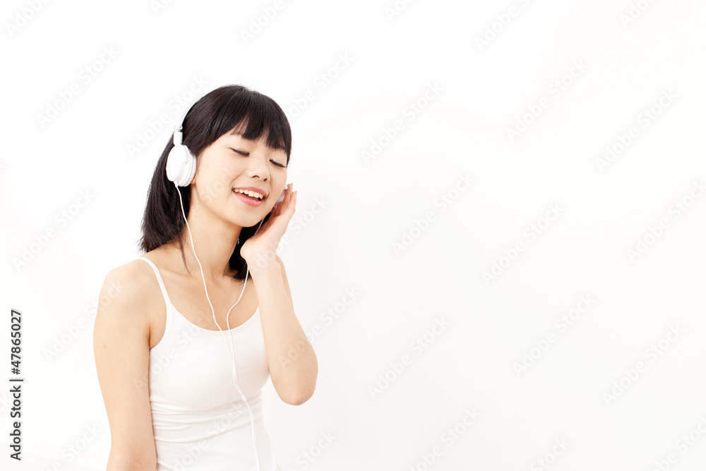 attractive asian woman listening to music