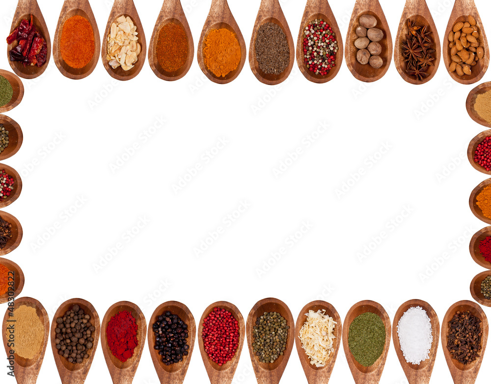 Various kinds of spices in heart shape on white background. 