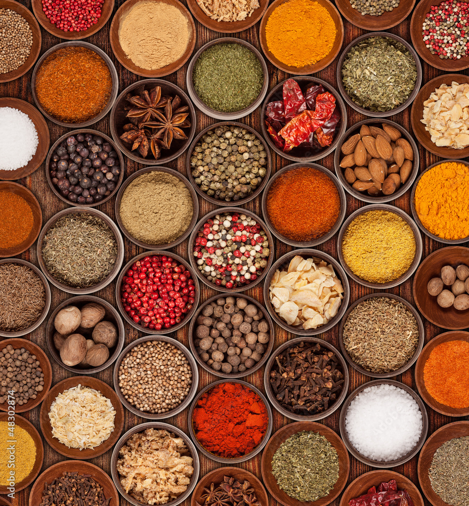 Various kinds of spices on wooden background