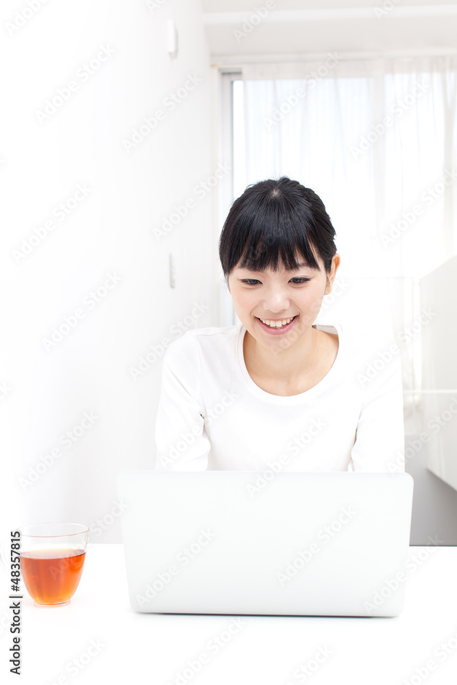 a young asian woman using laptop computer