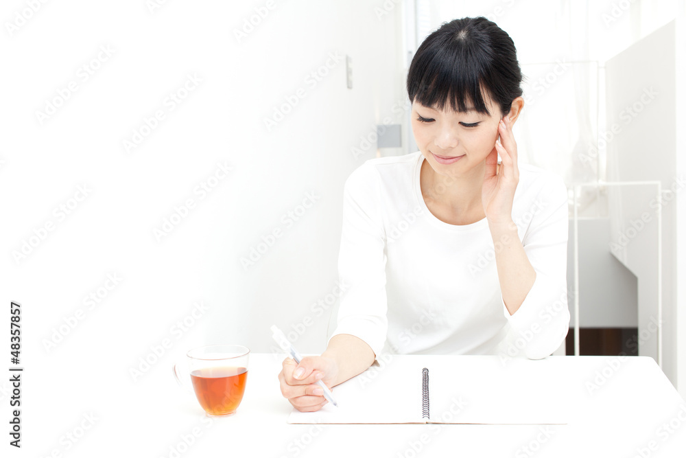 a young asian woman studying