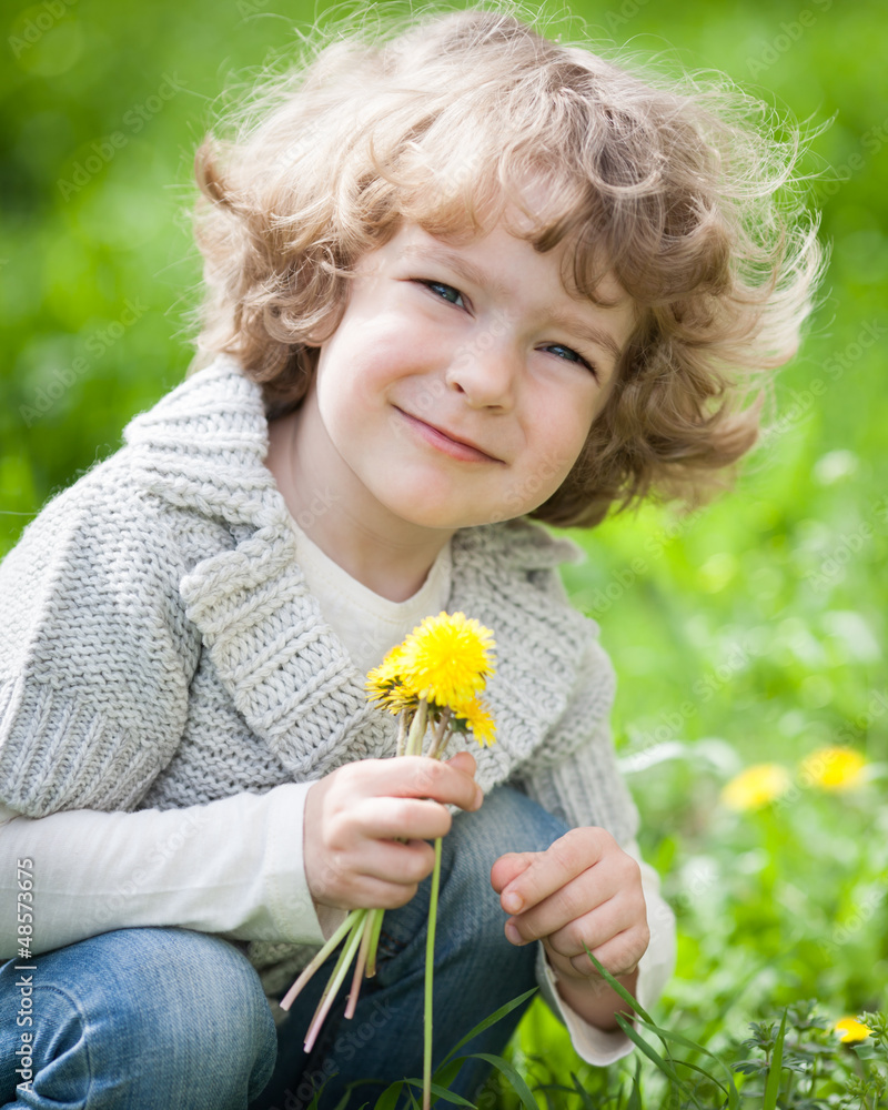 Child with bunch of dandelion