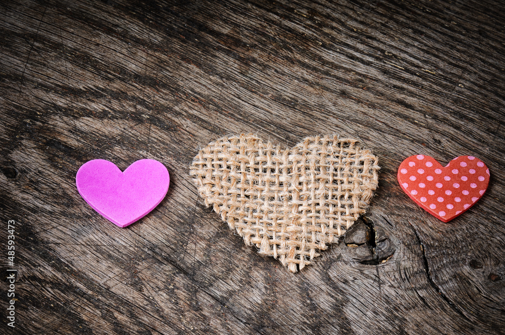 Colorful hearts on wooden background