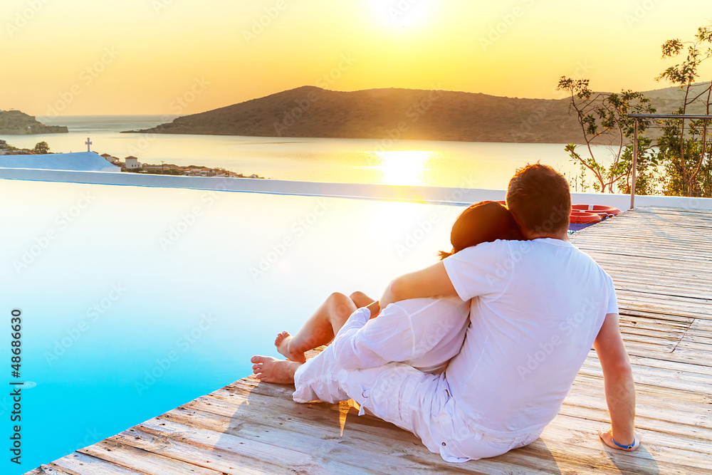 Couple in hug watching sunrise together