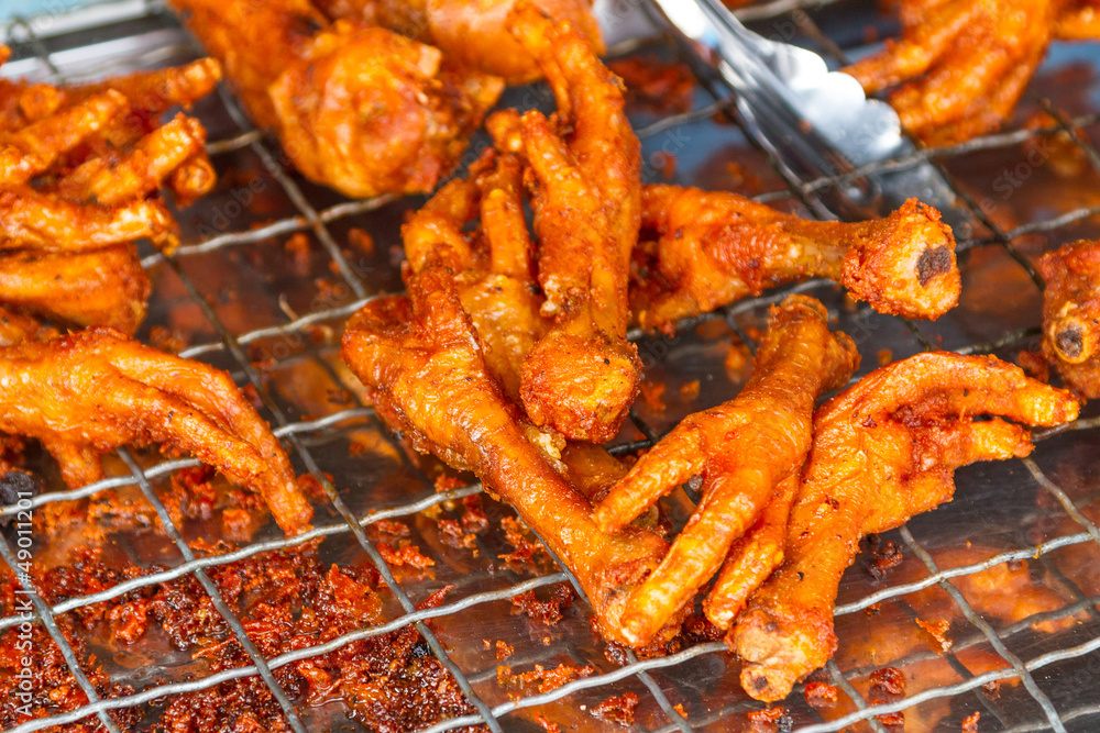 Deep fried chicken feet on the local market in Thailand