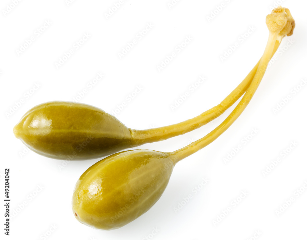 Close-up shot of two marinated capers  isolated on white