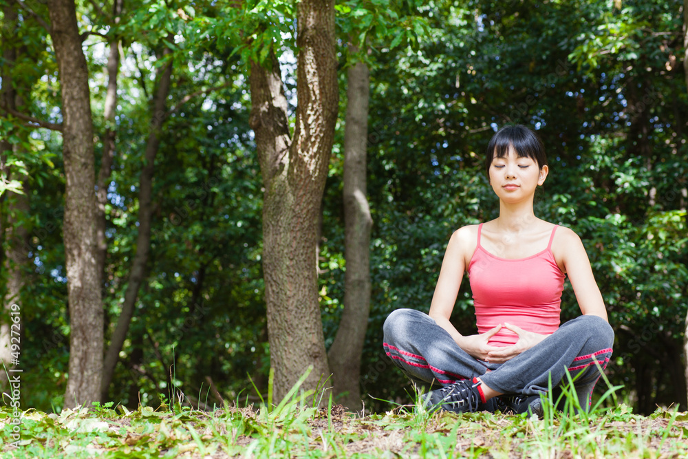 attractive asian woman relaxing in the park