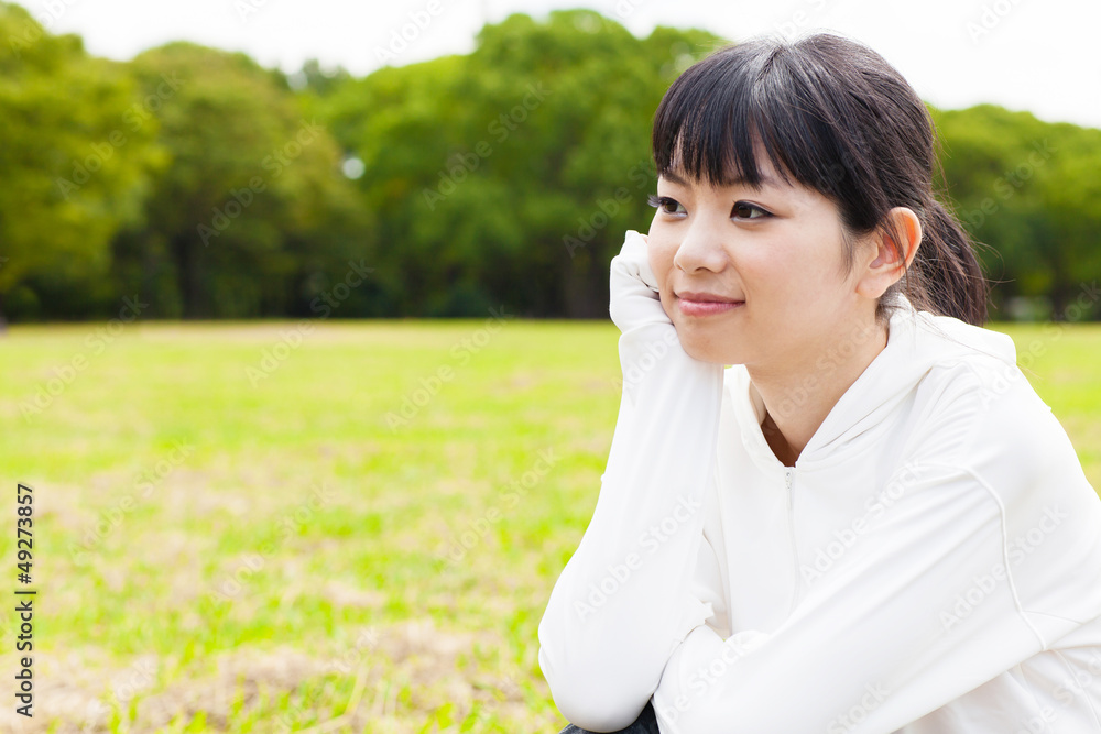 attractive asian woman relaxing in the park