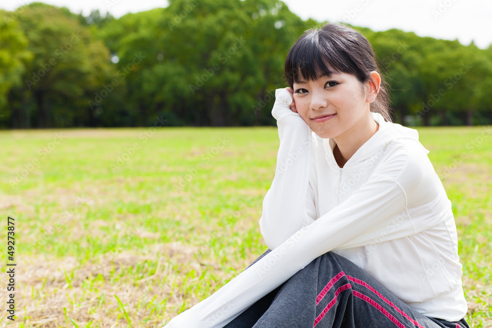 attractive asian woman relaxing in the park