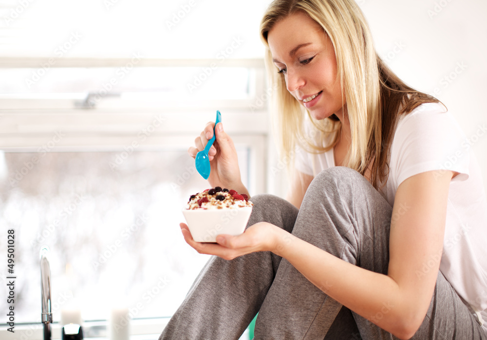 Woman smiling as she tucks into breakfast