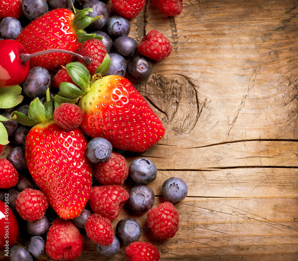 Berries on Wooden Background. Organic Berry over Wood