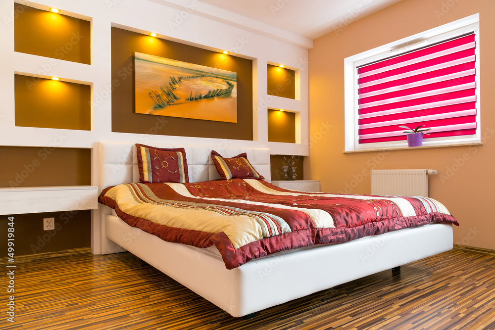 Master bedroom interior with picture of shipwreck on the wall