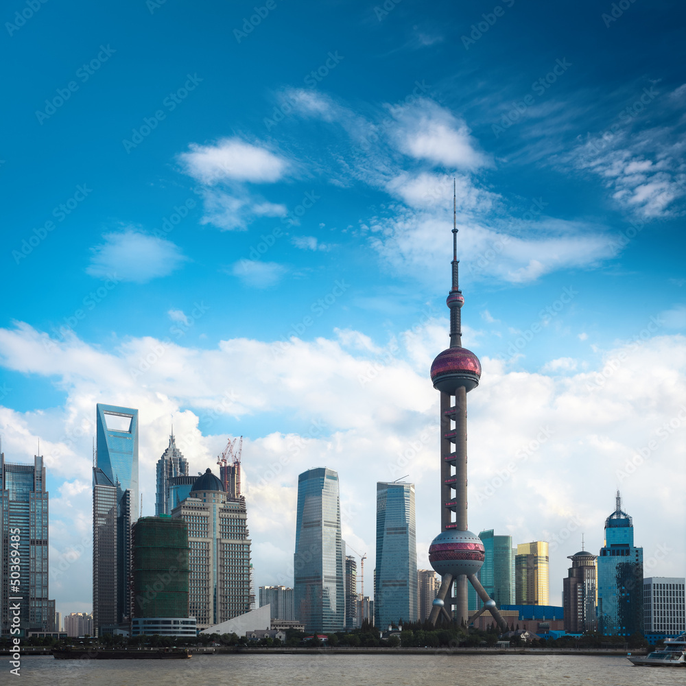 shanghai skyline against a blue sky