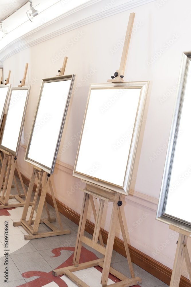 Corridor with blank frames on painting easel