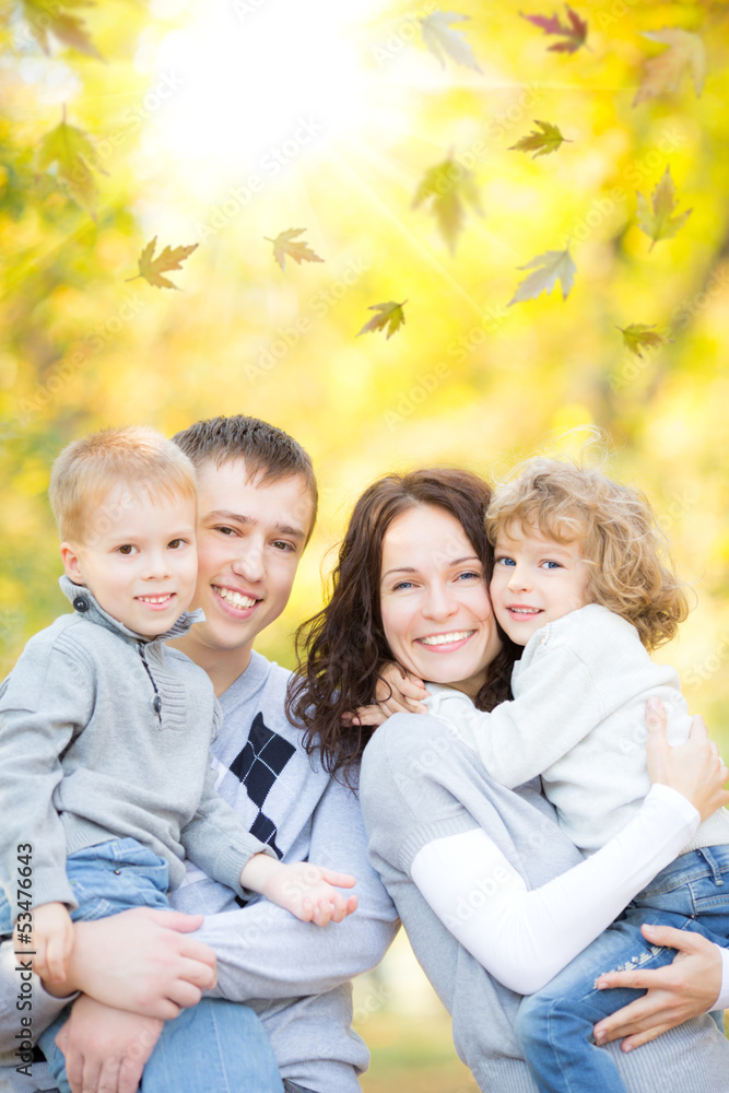 Happy family in autumn park