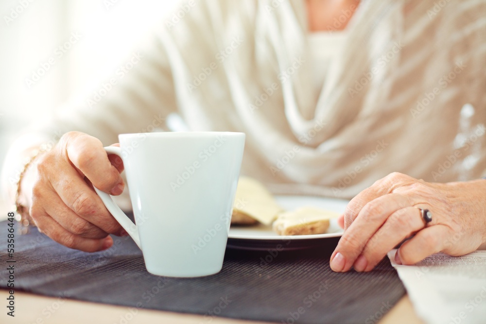 Wrinkled Hands with a Cup of Coffee