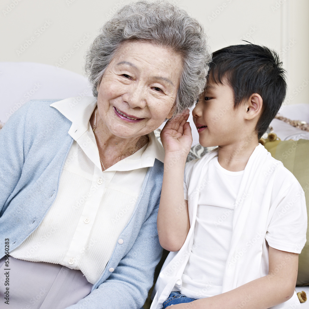 grandson telling a secret to grandma