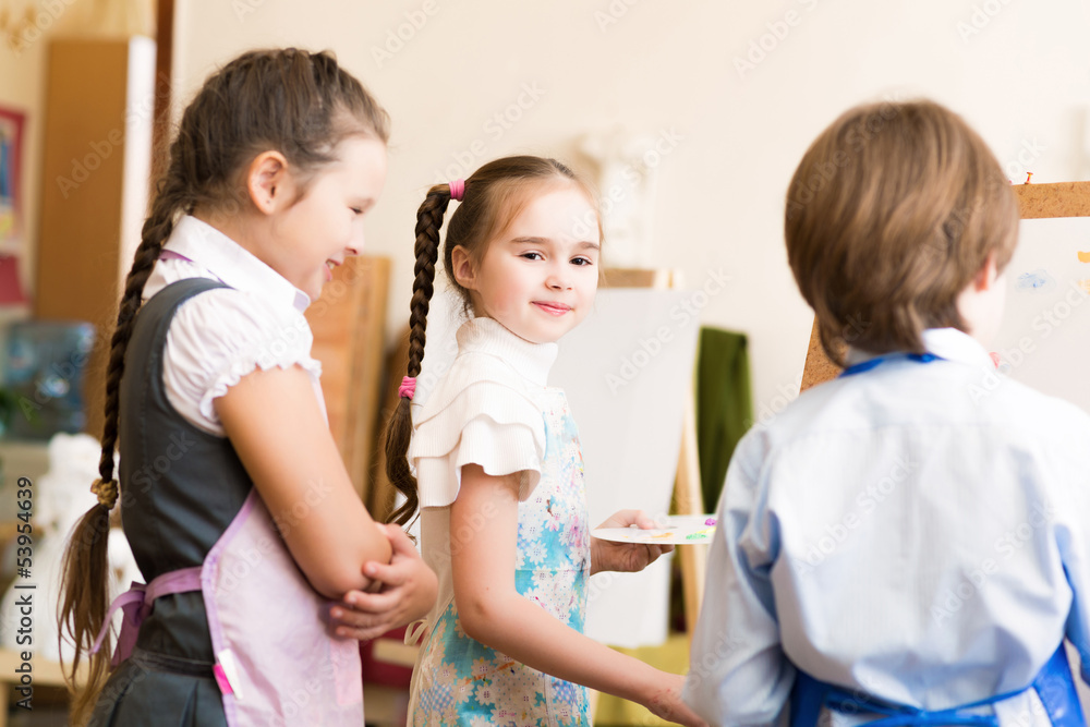 children draw pictures of easels