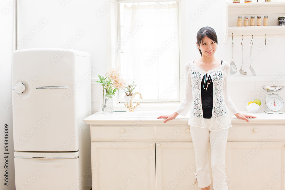 young asian woman relaxing in the kitchen