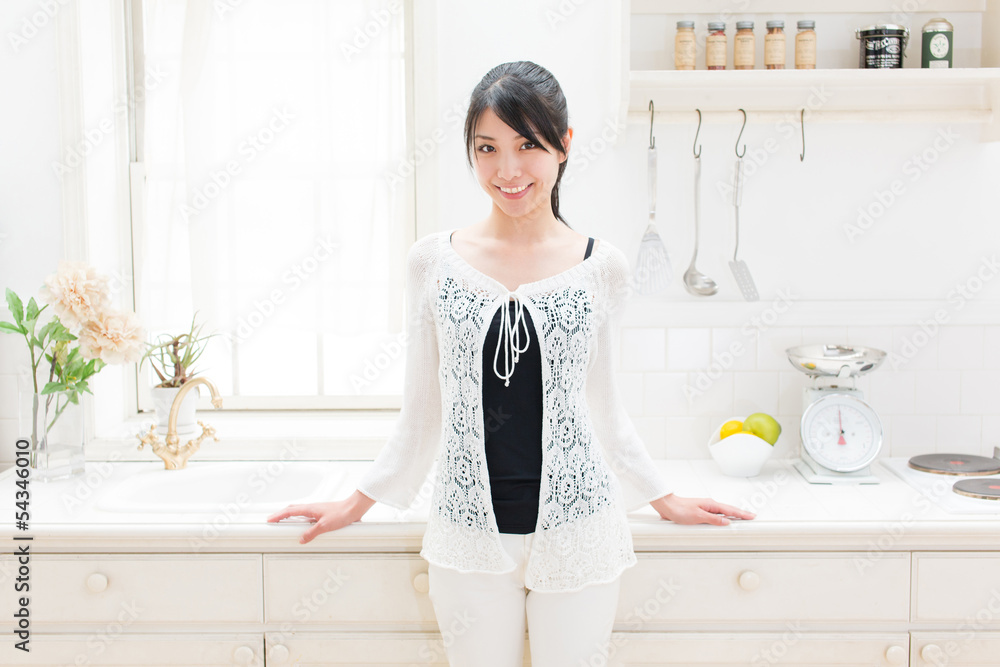 young asian woman relaxing in the kitchen