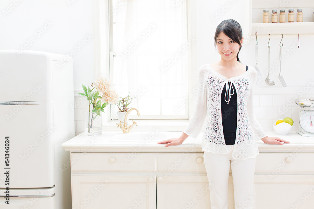 young asian woman relaxing in the kitchen