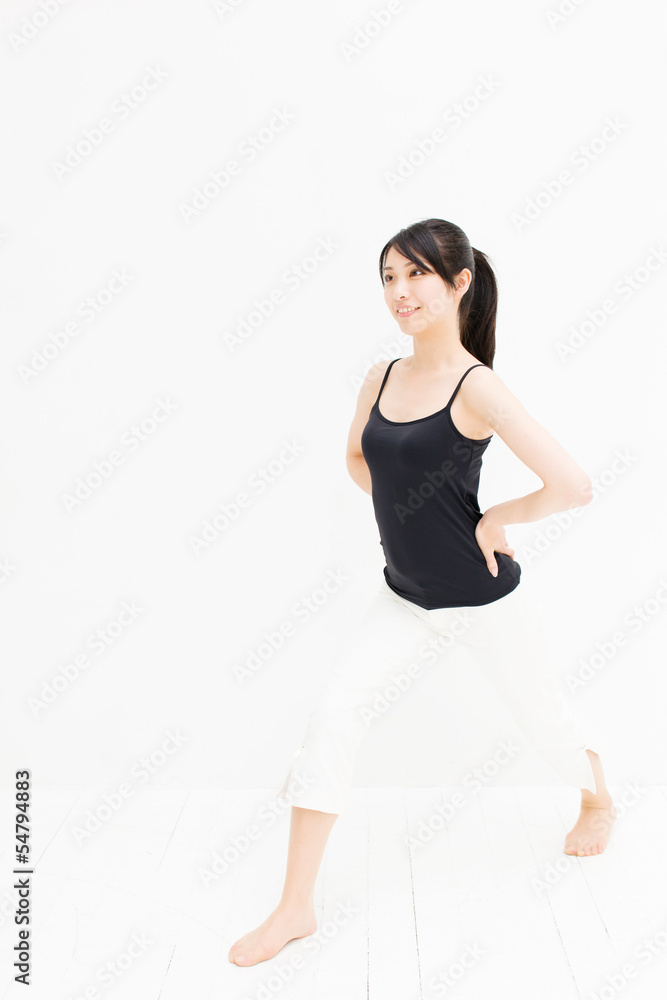 attractive asian woman exercising on white background