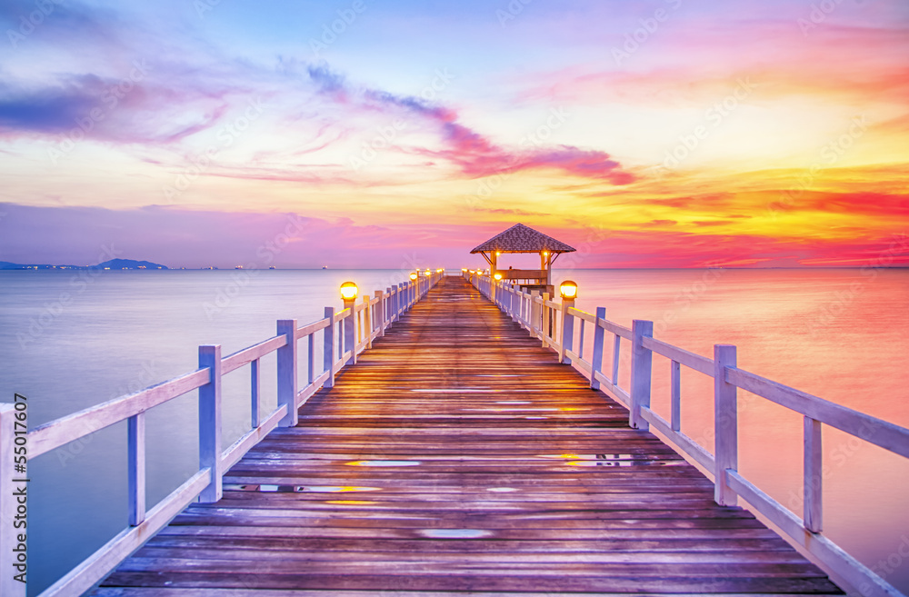 Wooded bridge in the port between sunrise