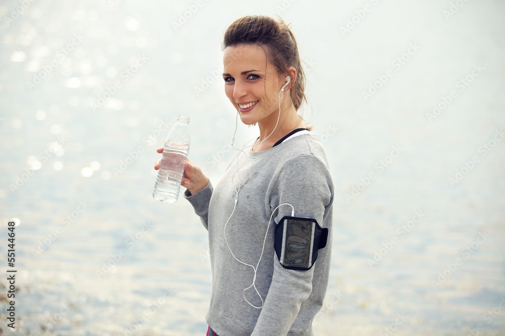 Happy Female Runner with Bottled Water