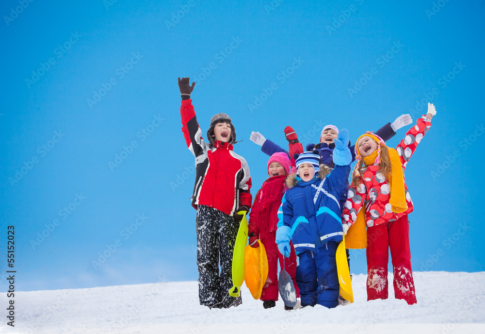 Group of kids waiving hands on snow day