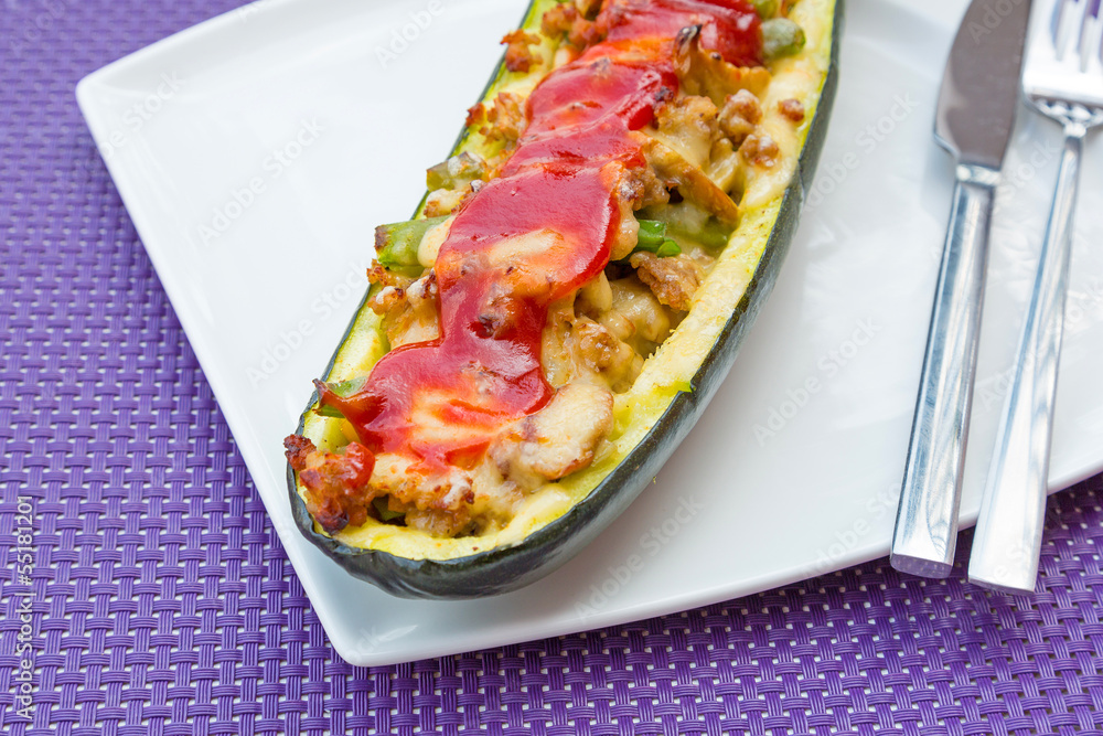 Zucchini halves stuffed with minced meat, vegetables and cheese