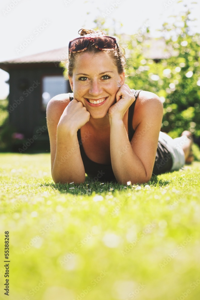 Happy Smiling Woman Relaxing on Grass