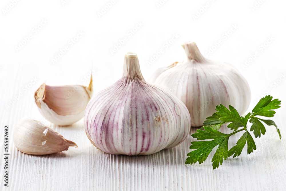 garlic and parsley on a white wooden table