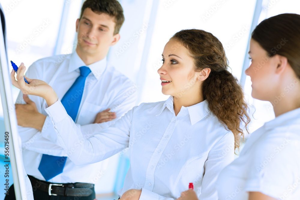 businessmen are meeting near the flipchart