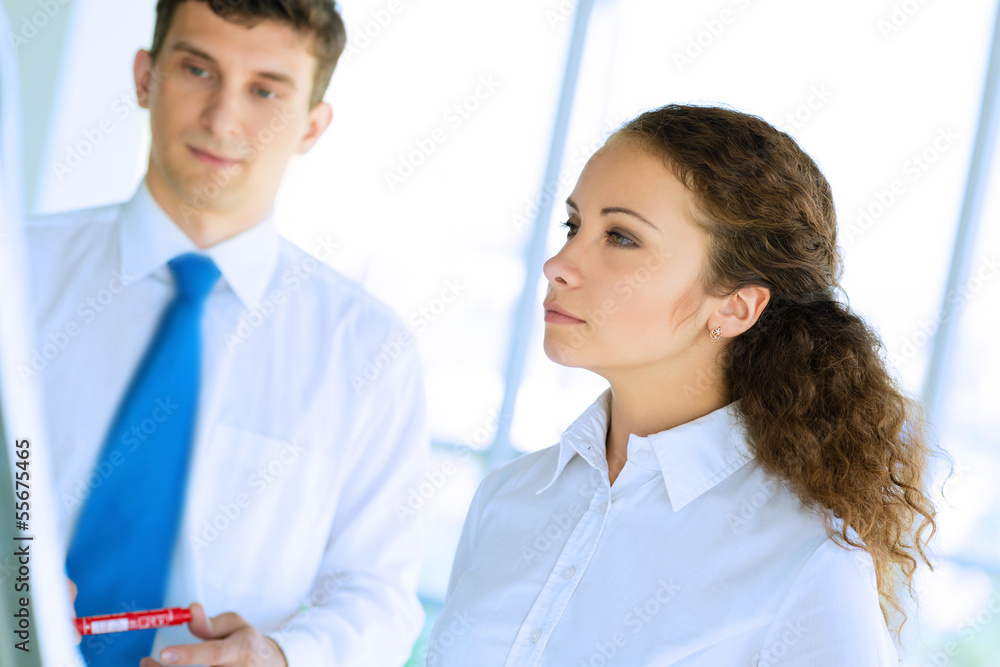 businessmen are meeting near the flipchart