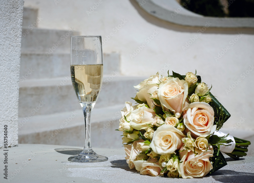 wedding bouquet and glass of champagne