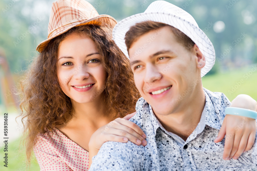 couple lying on the grass in the summer park