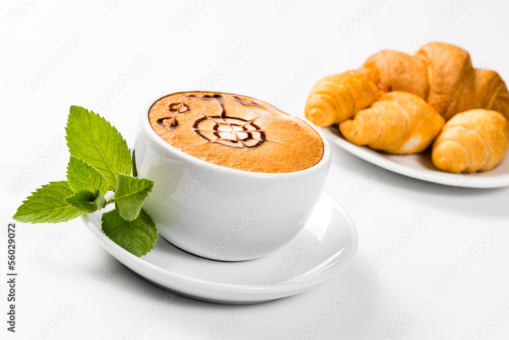 large cup of coffee and croissants on a plate