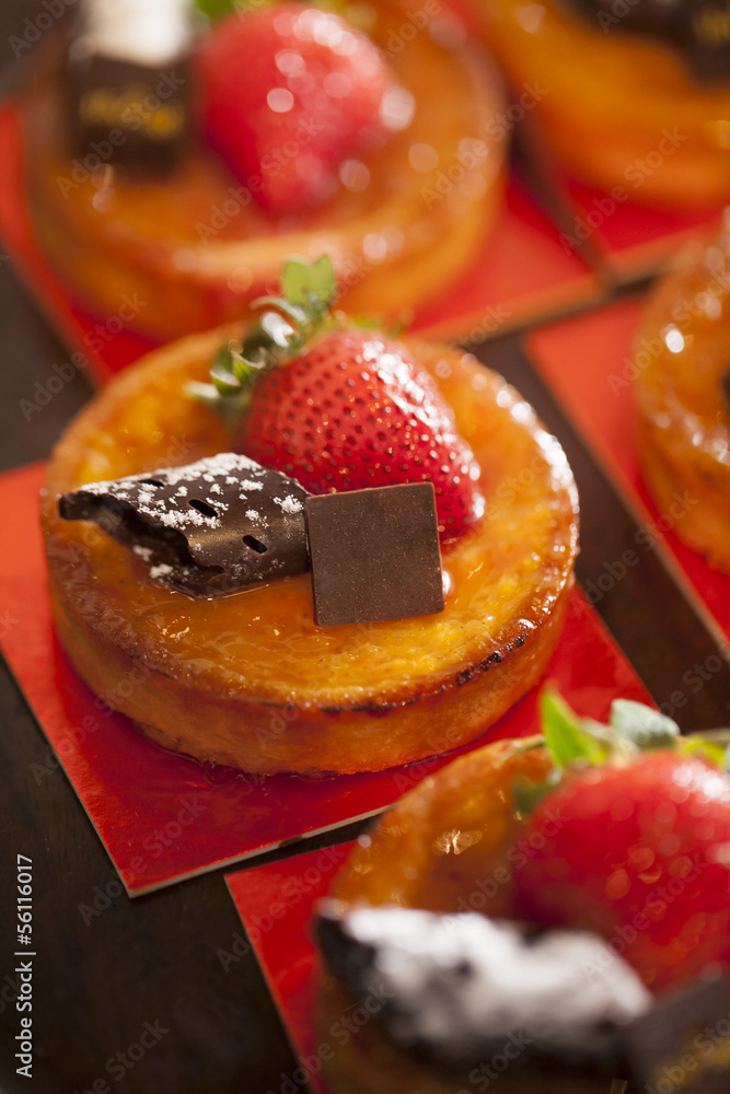 Tarts with chocolate and strawberry on top in party