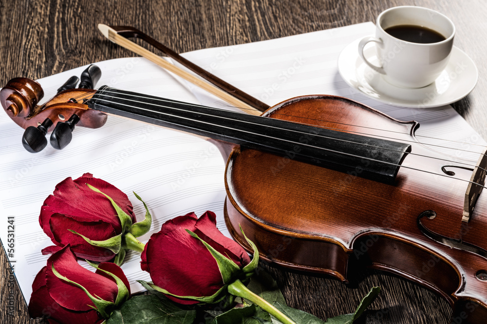 Violin, rose, glass of champagne and music books