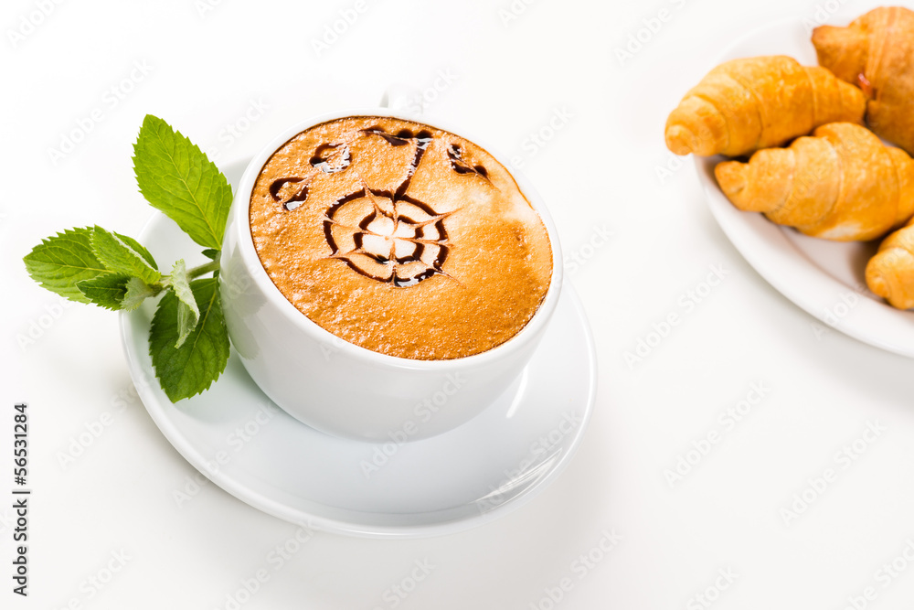 large cup of coffee and croissants on a plate