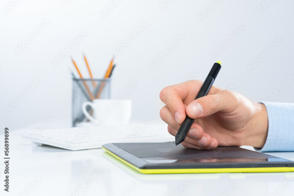 Designer hand drawing a graph on the tablet