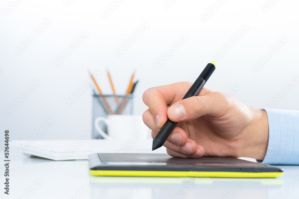 Designer hand drawing a graph on the tablet