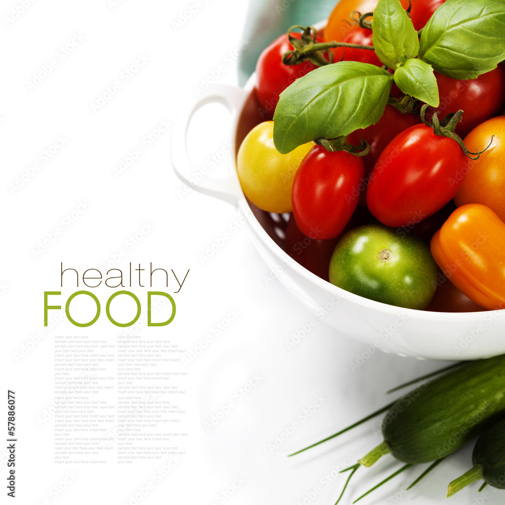 Assorted tomatoes and vegetables in colander