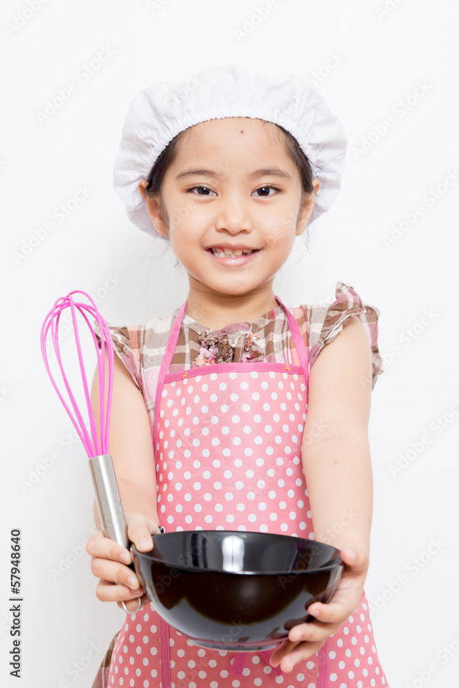 Little Asian cute chef wearing pink apron