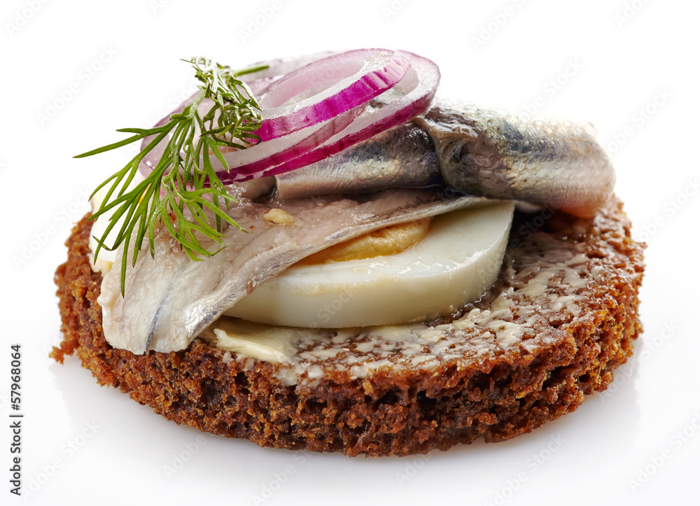 brown bread canape with anchovies decorated with red onion and d