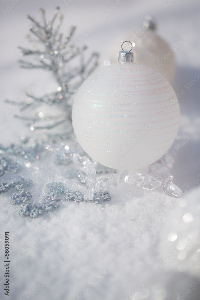 Silver Christmas decorations on snow. Shallow depth of fields