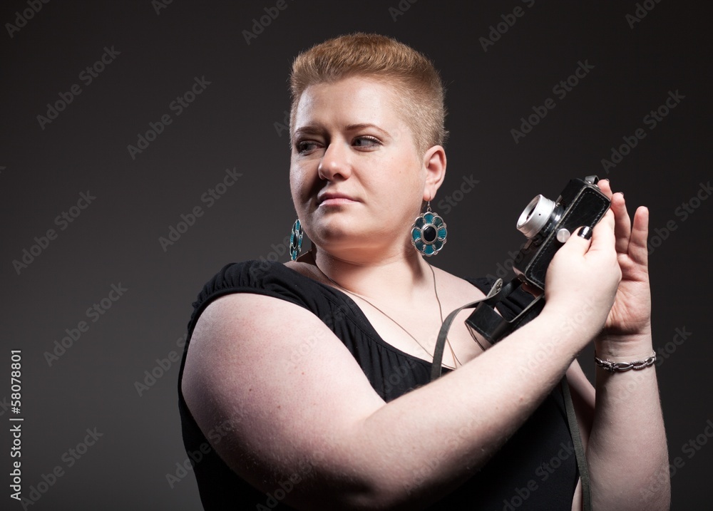 Chubby woman taking pictures of old camera