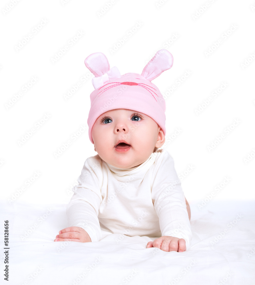 baby girl in a pink hat with rabbit ears isolated on white