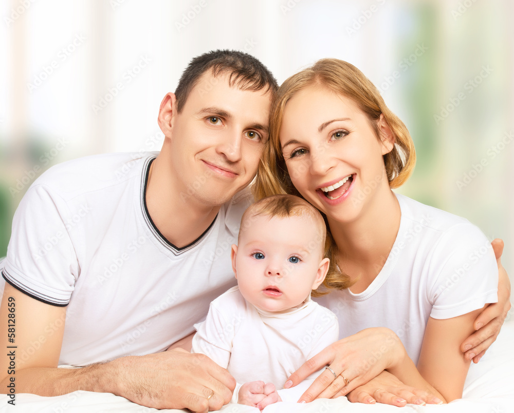 happy family of father, mother and small  baby girl daughter in