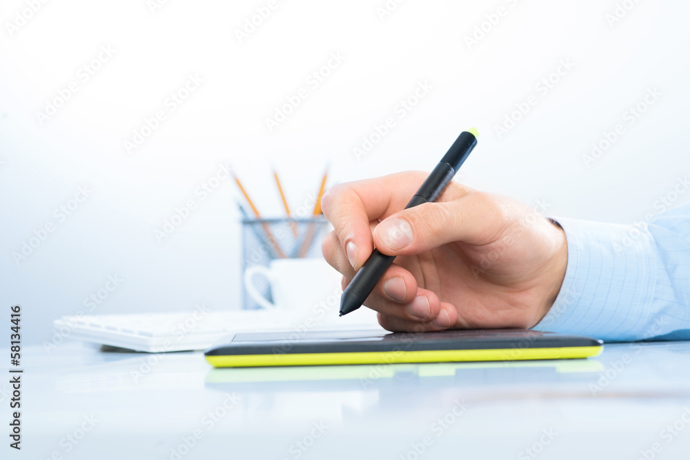 Designer hand drawing a graph on the tablet